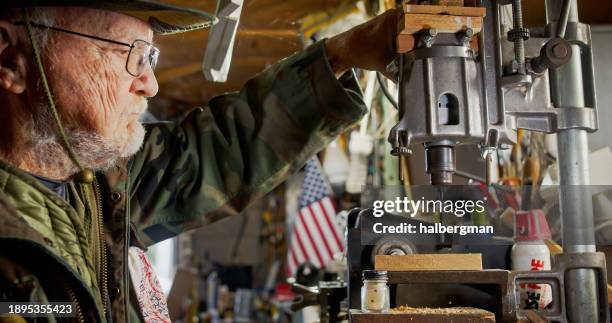elderly man working inside key-making workshop - old hand tools stock pictures, royalty-free photos & images
