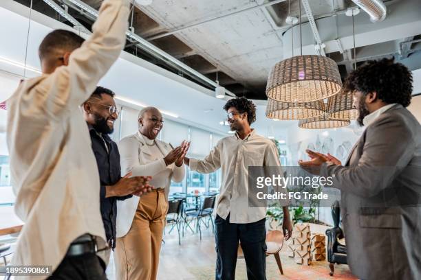 coworkers celebrating on the office - real people talking stock pictures, royalty-free photos & images