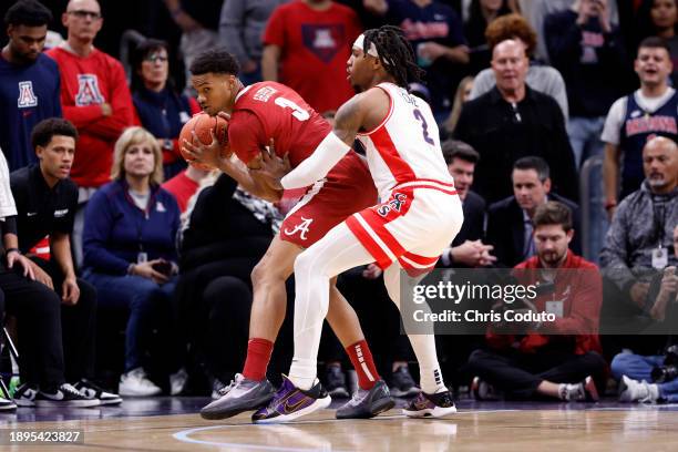 Rylan Griffen of the Alabama Crimson Tide posts up on Caleb Love of the Arizona Wildcats during the first half of the Jerry Colangelo's 2023 Hall of...