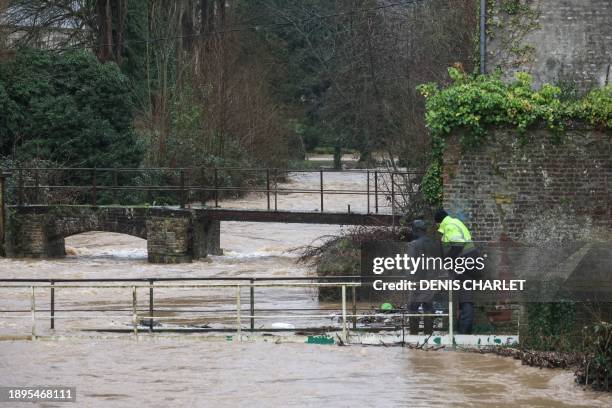 Municipal employee looks at the high levels of the river Aa, as it threatens to overflow, in Blendecques, northern France, on January 2, 2024. A...