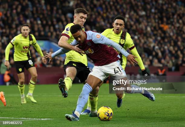 Jacob Ramsey of Villa holds off Dara O'Shea and Aaron Ramsey of Burnley during the Premier League match between Aston Villa and Burnley FC at Villa...