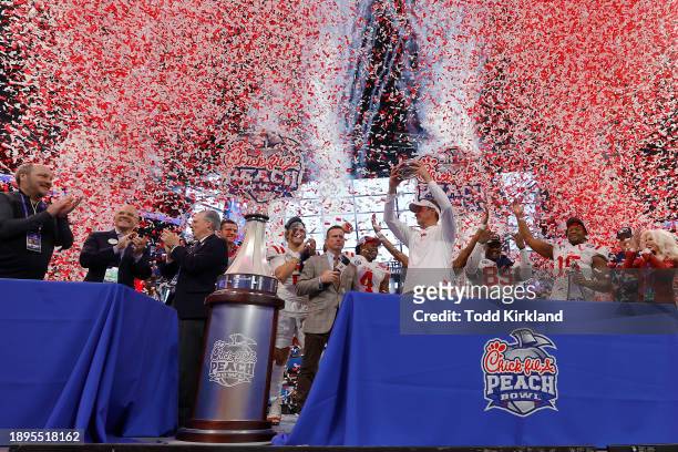 Head coach Lane Kiffin of the Mississippi Rebels celebrates with the team after beating Penn State Nittany Lions during the Chick-fil-A Peach Bowl at...