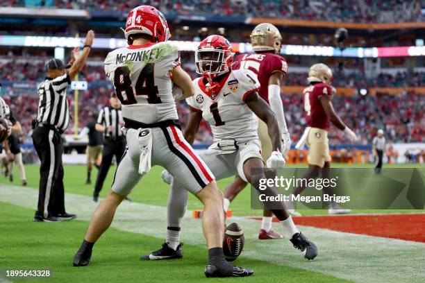 Ladd McConkey and Marcus Rosemy-Jacksaint of the Georgia Bulldogs celebrate after McConkey scored a touchdown in the second quarter against the...