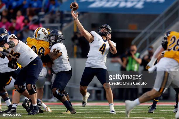 Quarterback Tucker Gleason of the Toledo Rockets throws a pass during the first half of the Barstool Sports Arizona Bowl game against the Wyoming...