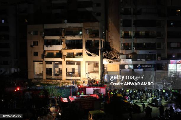 Lebanese emergency responders gather at the site of a strike, reported by Lebanese media to be an Israeli strike targeting a Hamas office, in the...