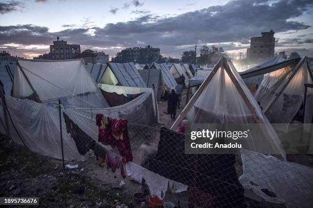 Palestinian families who had to leave their homes continue their lives in the tent city where they took shelter to protect themselves from Israeli...