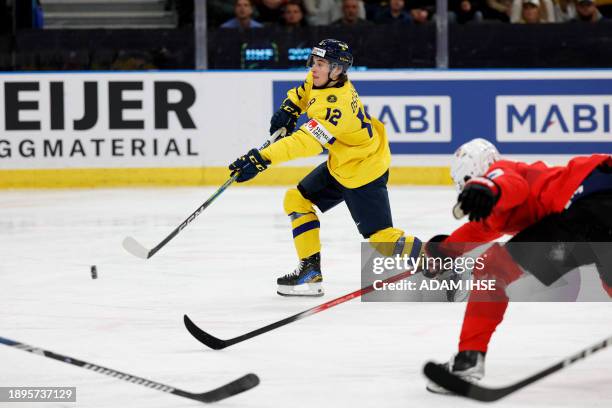 Sweden's Noah Ostlund passes the puck during the quarter-final match between Sweden and Switzerland of the IIHF World Junior Championship in...