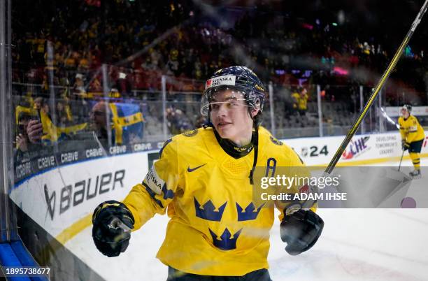 Sweden's Axel Sandin-Pellikka celebrates scoring the winning goal during the quarter-final match between Sweden and Switzerland of the IIHF World...