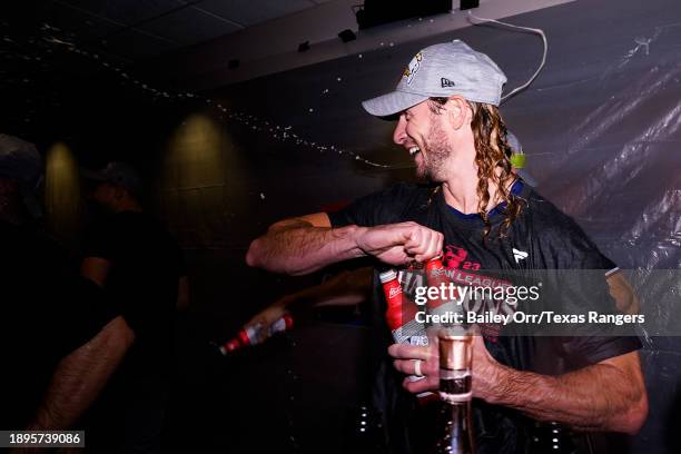 Travis Jankowski of the Texas Rangers celebrates in the locker room after defeating the Houston Astros in Game Seven to win the American League...