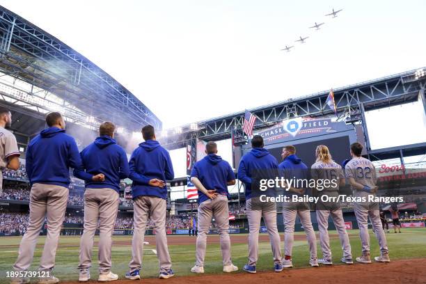 The Texas Rangers line the base path during the national anthem prior to Game Four of the World Series against the Arizona Diamondbacks at Chase...