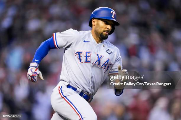 Marcus Semien of the Texas Rangers rounds the bases after hitting a two-run RBI triple in the second inning during Game Four of the World Series...