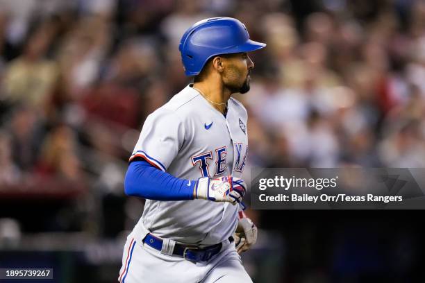 Marcus Semien of the Texas Rangers hits a three-run home run in the third inning during Game Four of the World Series against the Arizona...