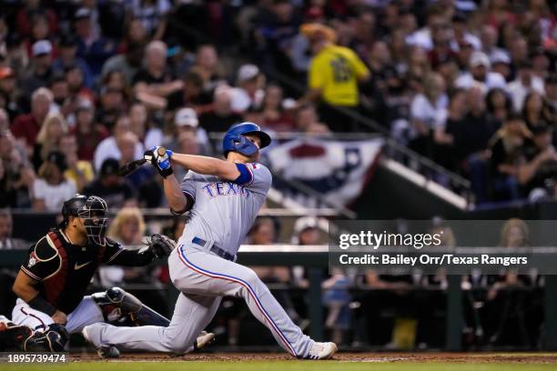 Corey Seager of the Texas Rangers hits a two-run home run in the second inning during Game Four of the World Series against the Arizona Diamondbacks...