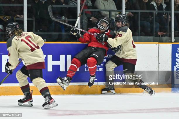 Sarah Bujold of Montreal checks Mikyla Grant-Mentis of Ottawa during the first period of a Professional Women's Hockey League game at The Arena at TD...