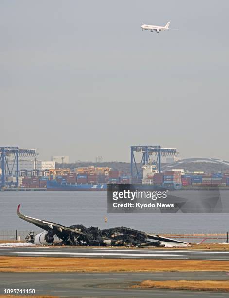 Photo taken on Jan. 3 shows a Japan Airlines plane a day after it caught fire on a runway at Haneda airport in Tokyo following a collision with a...