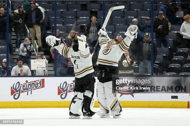 Jeremy Swayman of the Boston Bruins and Linus Ullmark of the Boston Bruins celebrate after defeating the Columbus Blue Jackets at Nationwide Arena on...