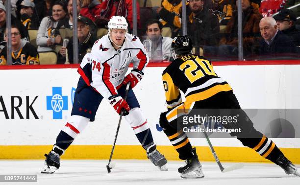 John Carlson of the Washington Capitals skates against Lars Eller of the Pittsburgh Penguins at PPG PAINTS Arena on January 2, 2023 in Pittsburgh,...
