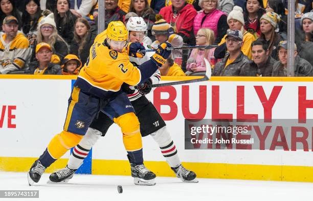 Luke Schenn of the Nashville Predators battles for the puck against Brett Seney of the Chicago Blackhawks during an NHL game at Bridgestone Arena on...