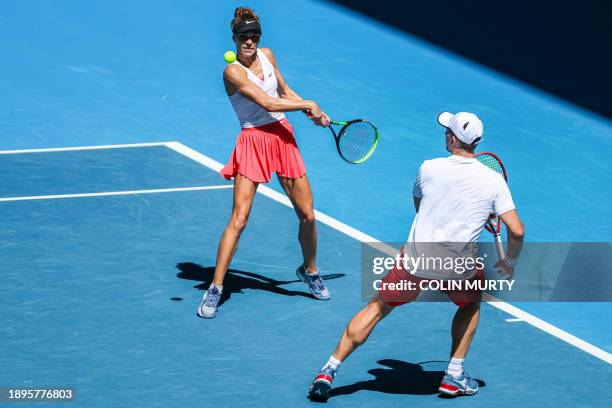 Poland's Katarzyna Piter and Jan Zielinski hit a return against China's You Xiaodi and Sun Fajing during their mixed doubles match at the United Cup...