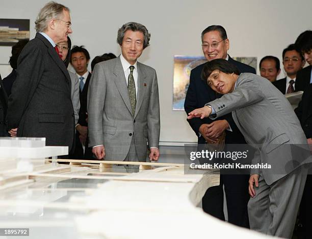 Japanese Prime Minister Junichiro Koizumi and Tadao Ando stand in front of a miniature of Pinault Contemporary Art Museum at an opening ceremony of...