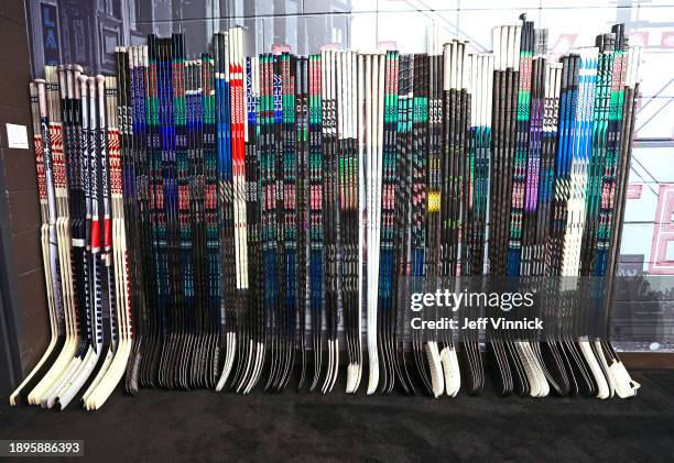 General view is seen of players' sticks line up on a wall in the Seattle Kraken locker room prior to the 2024 Discover NHL Winter Classic between the...