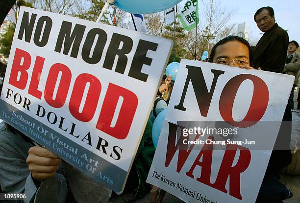 South Korean university students hold placards that read "No More Blood For Dollars" during an anti-war rally April 4, 2003 in Seoul, South Korea....