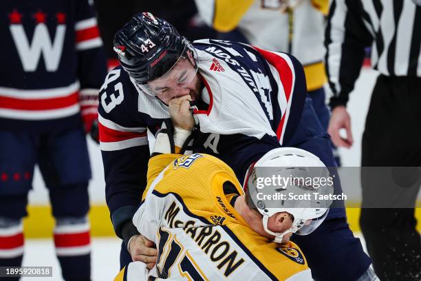 Tom Wilson of the Washington Capitals and Michael McCarron of the Nashville Predators fight during the first period of the game at Capital One Arena...