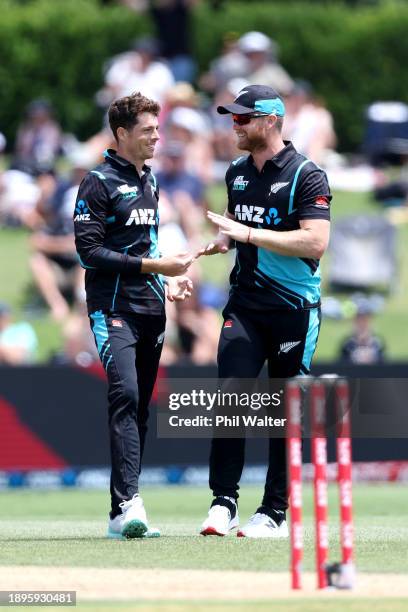 Mitchell Santner of New Zealand celebrates the wicket of Shamim Hossain of Bangladesh with James Neesham during game three of the Men's T20...