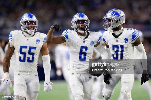 Ifeatu Melifonwu of the Detroit Lions celebrates with Derrick Barnes and Kerby Joseph after intercepting a pass thrown by Dak Prescott of the Dallas...