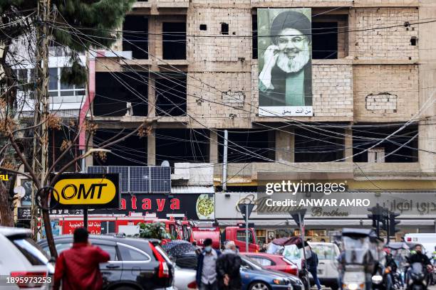 Picture depicting Hassan Nasrallah, the leader of the Lebanese Shiite movement Hezbollah, hangs on a building near the site of a drone strike...