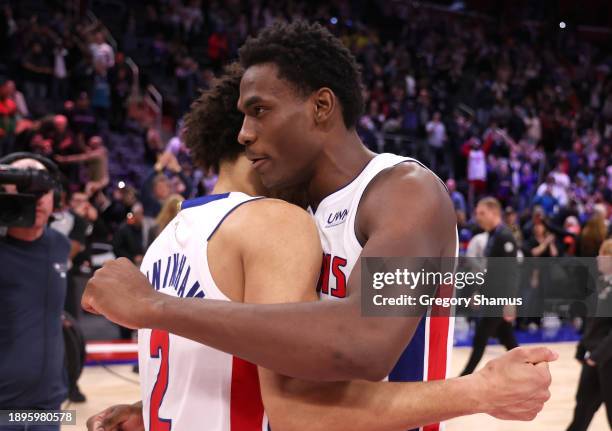 Jalen Duren and Cade Cunningham of the Detroit Pistons react to a 129-127 win over the Toronto Raptors at Little Caesars Arena on December 30, 2023...