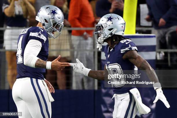 CeeDee Lamb of the Dallas Cowboys celebrates with Dak Prescott after scoring a 92 yard touchdown against the Detroit Lions during the first quarter...