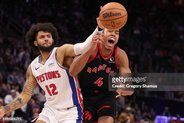Scottie Barnes of the Toronto Raptors battles for a loose ball against Isaiah Livers of the Detroit Pistons during the second half at Little Caesars...