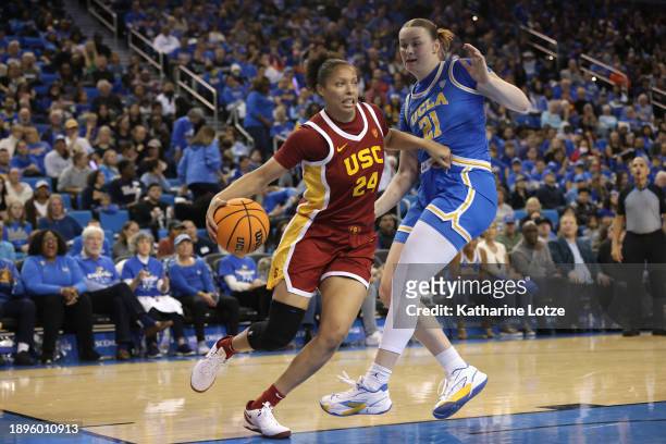 Kaitlyn Davis of the USC Trojans drives around Lina Sontag of the UCLA Bruins during the first half of a game at UCLA Pauley Pavilion on December 30,...