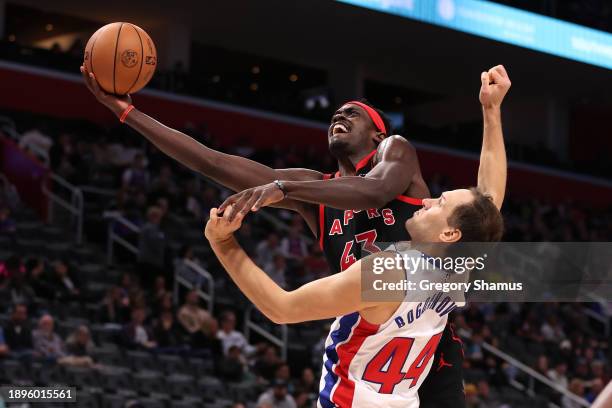 Pascal Siakam of the Toronto Raptors drives to the basket against Bojan Bogdanovic of the Detroit Pistons during the second half at Little Caesars...