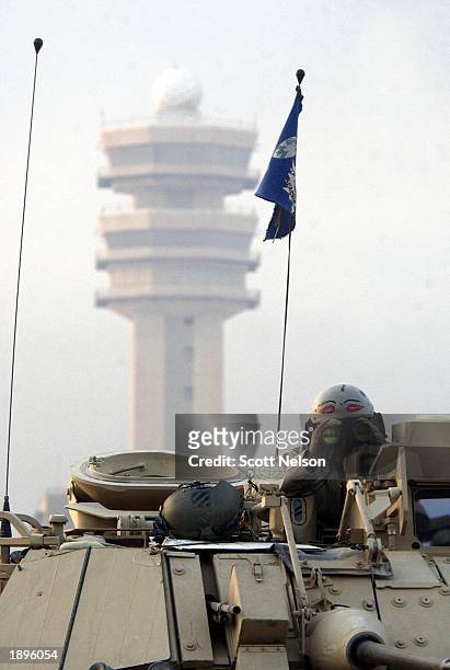 Army 3rd Division 3-7 Bradley fighting vehicle gunner watches as squads secure the main terminal of the Baghdad International Airport April 4, 2003...