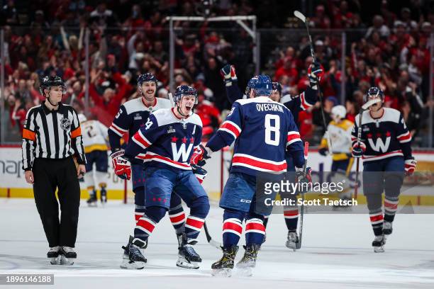 Alex Ovechkin of the Washington Capitals celebrates with John Carlson, and Joel Edmundson after scoring a goal against the Nashville Predators during...