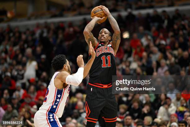 DeMar DeRozan of the Chicago Bulls shoots against Tobias Harris of the Philadelphia 76ers during the second half at the United Center on December 30,...