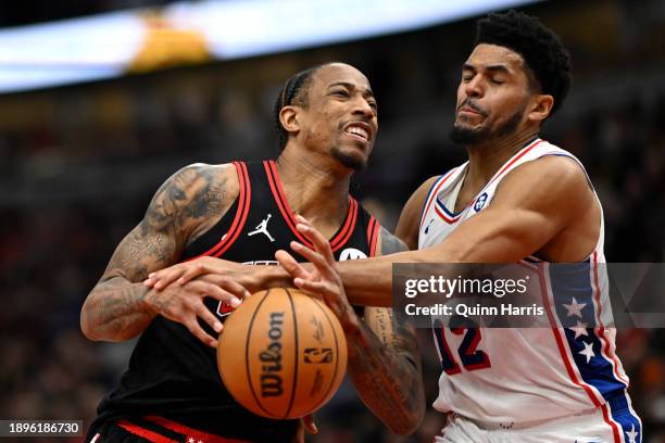 Tobias Harris of the Philadelphia 76ers knocks the ball away from DeMar DeRozan of the Chicago Bulls during the second half at the United Center on...