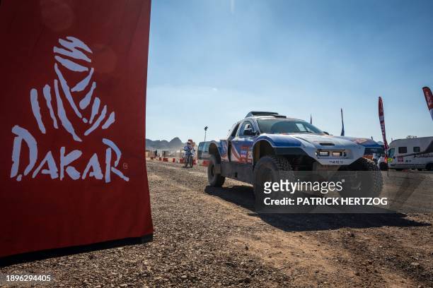 Competitors drive their cars into the bivouac before the Dakar 2024 rally in Al-Ula, Saudi Arabia, on January 3, 2024.