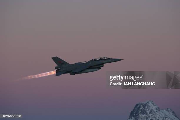 Norway's Minister of Defense, Bjørn Arild Gram, sits in the back of an F16 aircraft at Bodø airport, Norway, on January 3 where the final...