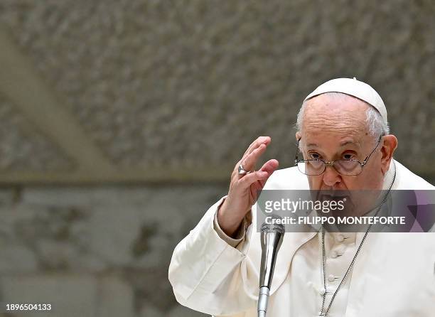 Pope Francis gives his blessing during the weekly general audience in Paul VI hall at the Vatican on January 3, 2024.