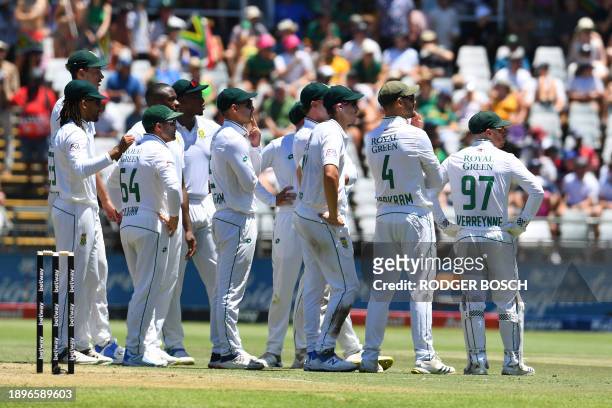 South African players watch the digital board during a review during the first day of the second cricket Test match between South Africa and India at...