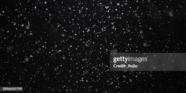 falling snowflakes against sky at night - snowing stock pictures, royalty-free photos & images