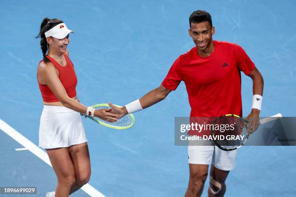 Canada's Felix Auger-Aliassime shakes hands with partner Stacey Fung during their mixed doubles match against Greece's Despina Papamichail and Petros...