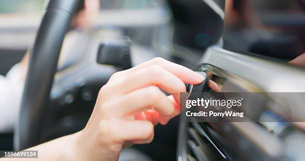 driver adjust volume in car - music from the motor city stock pictures, royalty-free photos & images