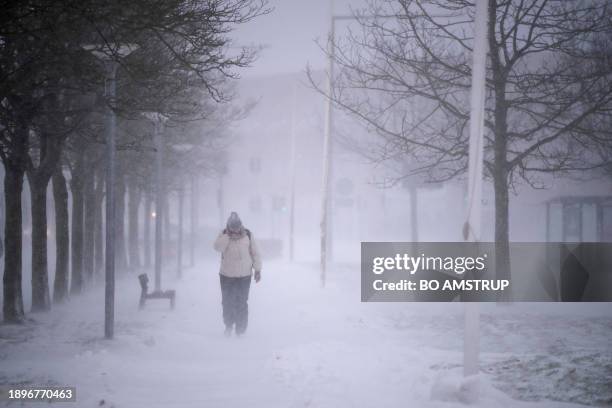 Person walks through heavy snowfall in Randers, Denmark on January 3, 2024. / Denmark OUT