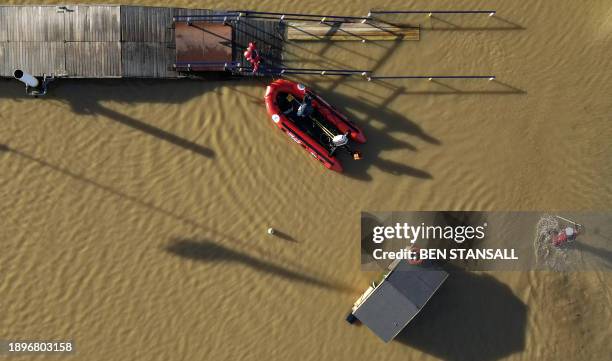 An aerial view shows Members of Northamptonshire Fire and Rescue service working to evacuate residents at Billing Aquadrome after the River Nene...