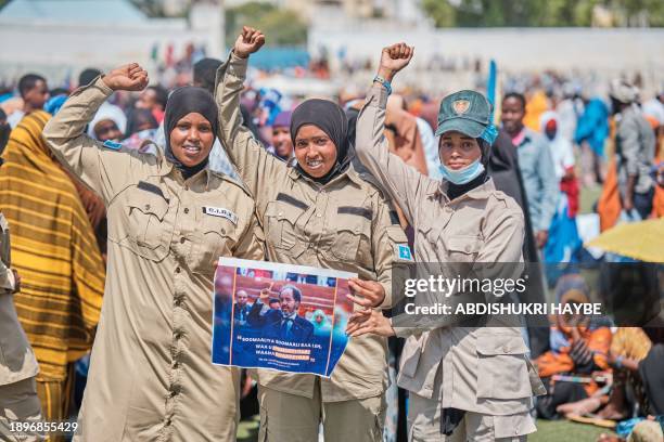 Somali Police officers hold a banner with a quote from Somalia's President Hassan Sheikh Mohamud during a demonstration in support of Somalia's...