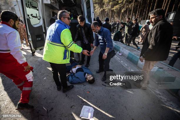 Iranian emergency services arrive at the site where two explosions in quick succession struck a crowd marking the anniversary of the 2020 killing of...